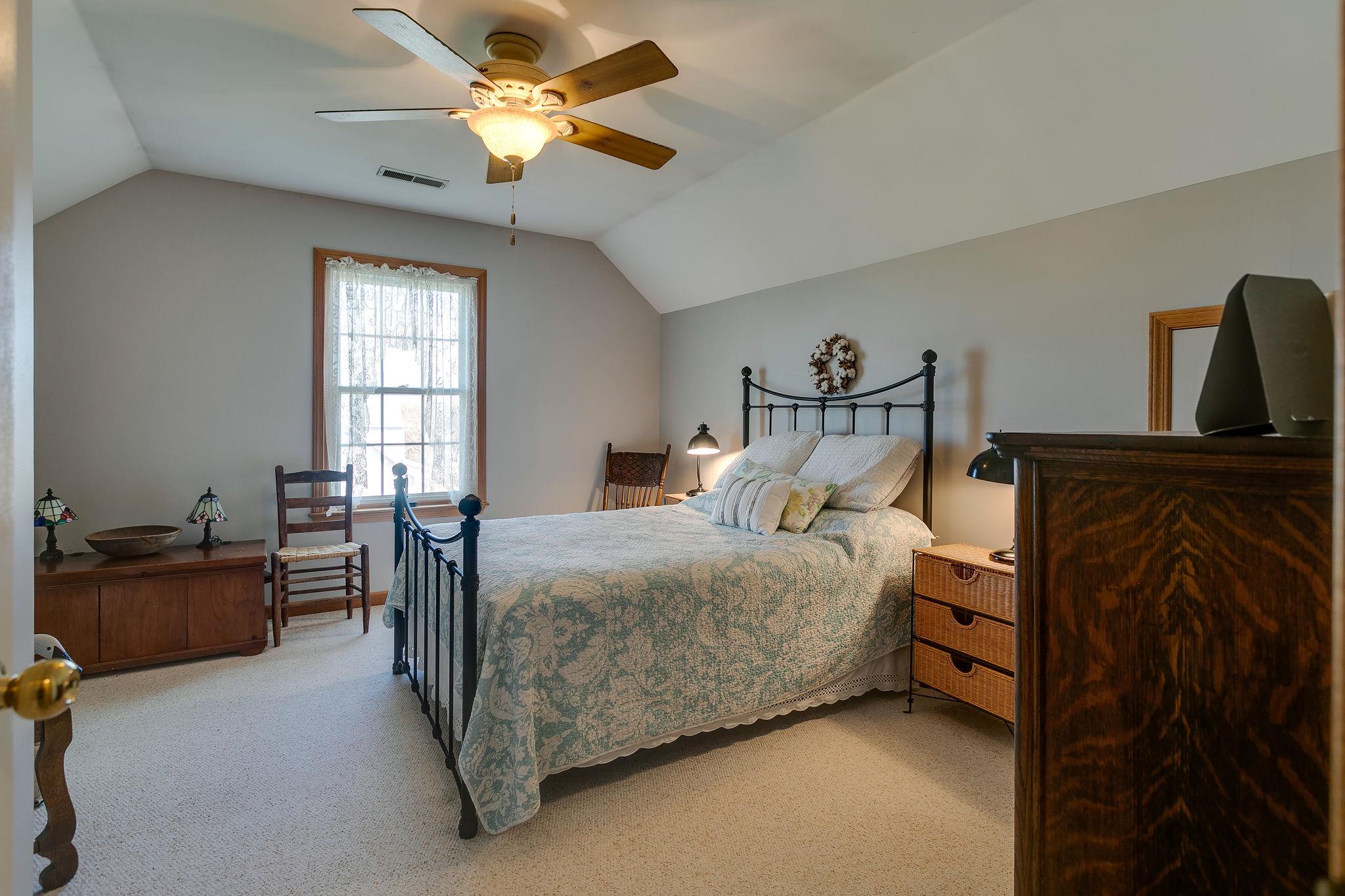 3467 Greens Mill Road Spring Hill, TN 37174 - Photo 11 of 28 a bedroom with a bed and a chandelier
