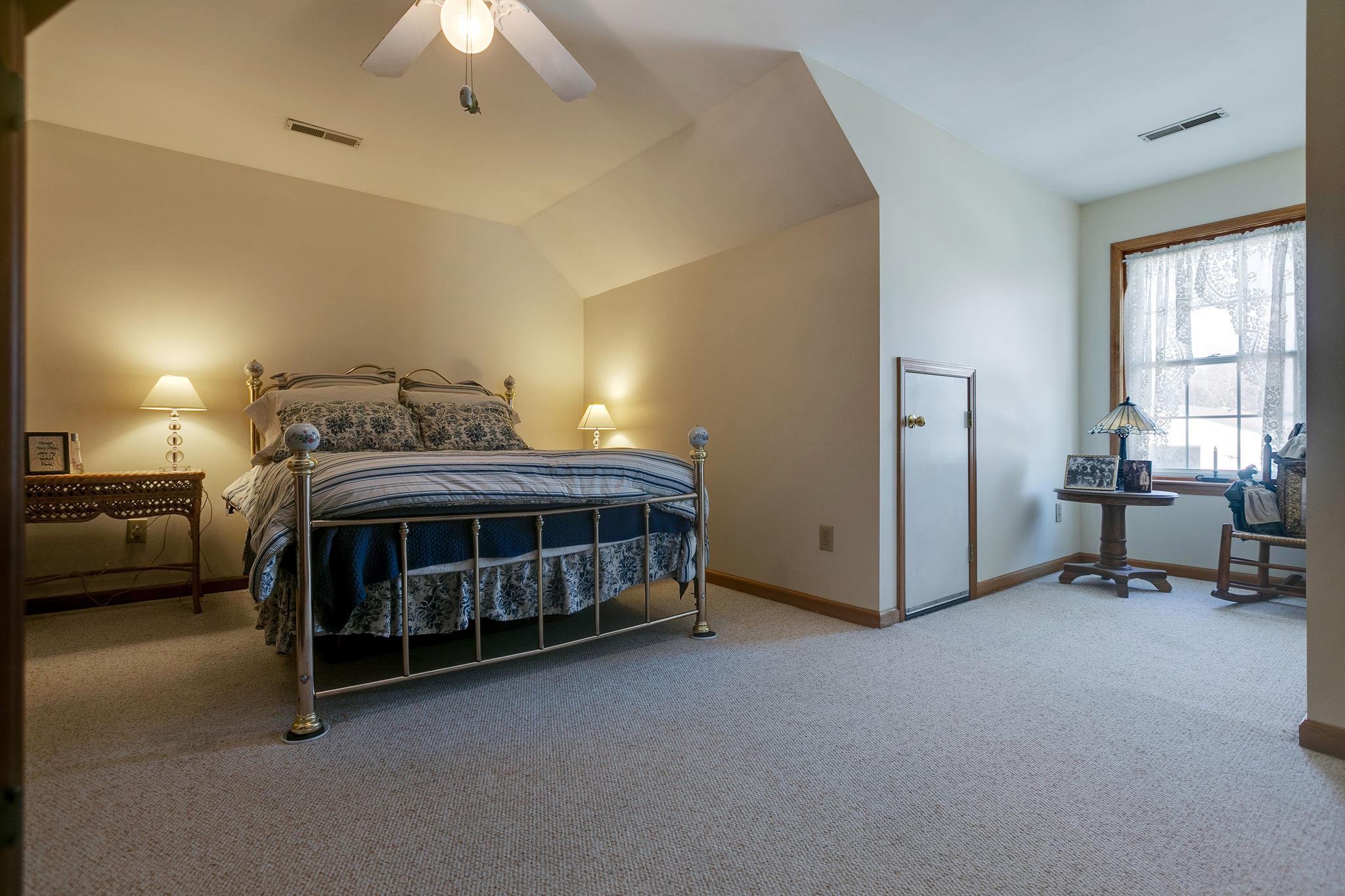 3467 Greens Mill Road Spring Hill, TN 37174 - Photo 12 of 28 a bedroom with bed and a chandelier