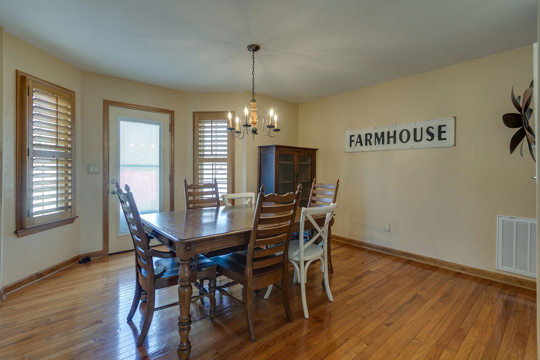 3467 Greens Mill Road Spring Hill, TN 37174 - Photo 14 of 28 a view of a dining room with furniture window and wooden floor