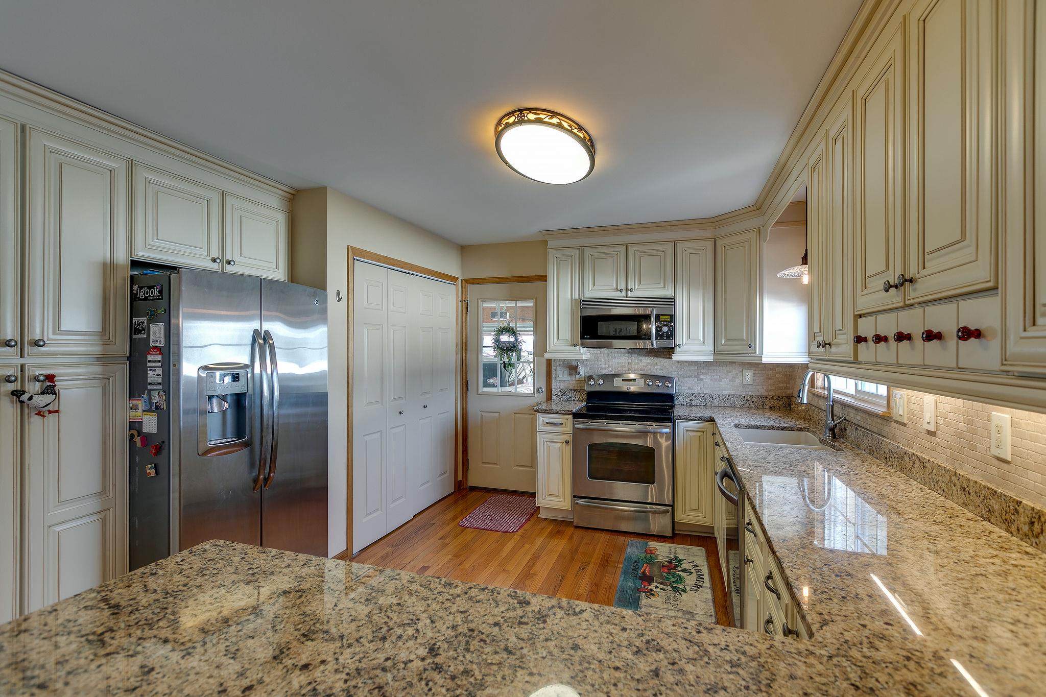 3467 Greens Mill Road Spring Hill, TN 37174 - Photo 15 of 28 a kitchen with stainless steel appliances granite countertop a refrigerator a stove top oven a sink and dishwasher
