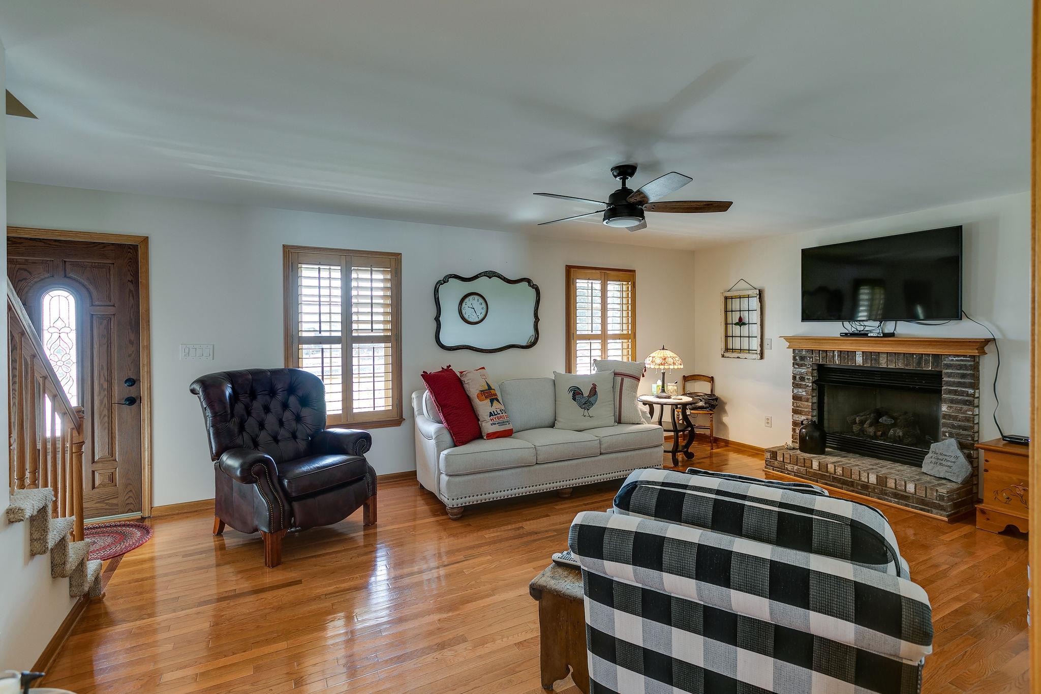 3467 Greens Mill Road Spring Hill, TN 37174 - Photo 19 of 28 a living room with furniture a fireplace and a flat screen tv