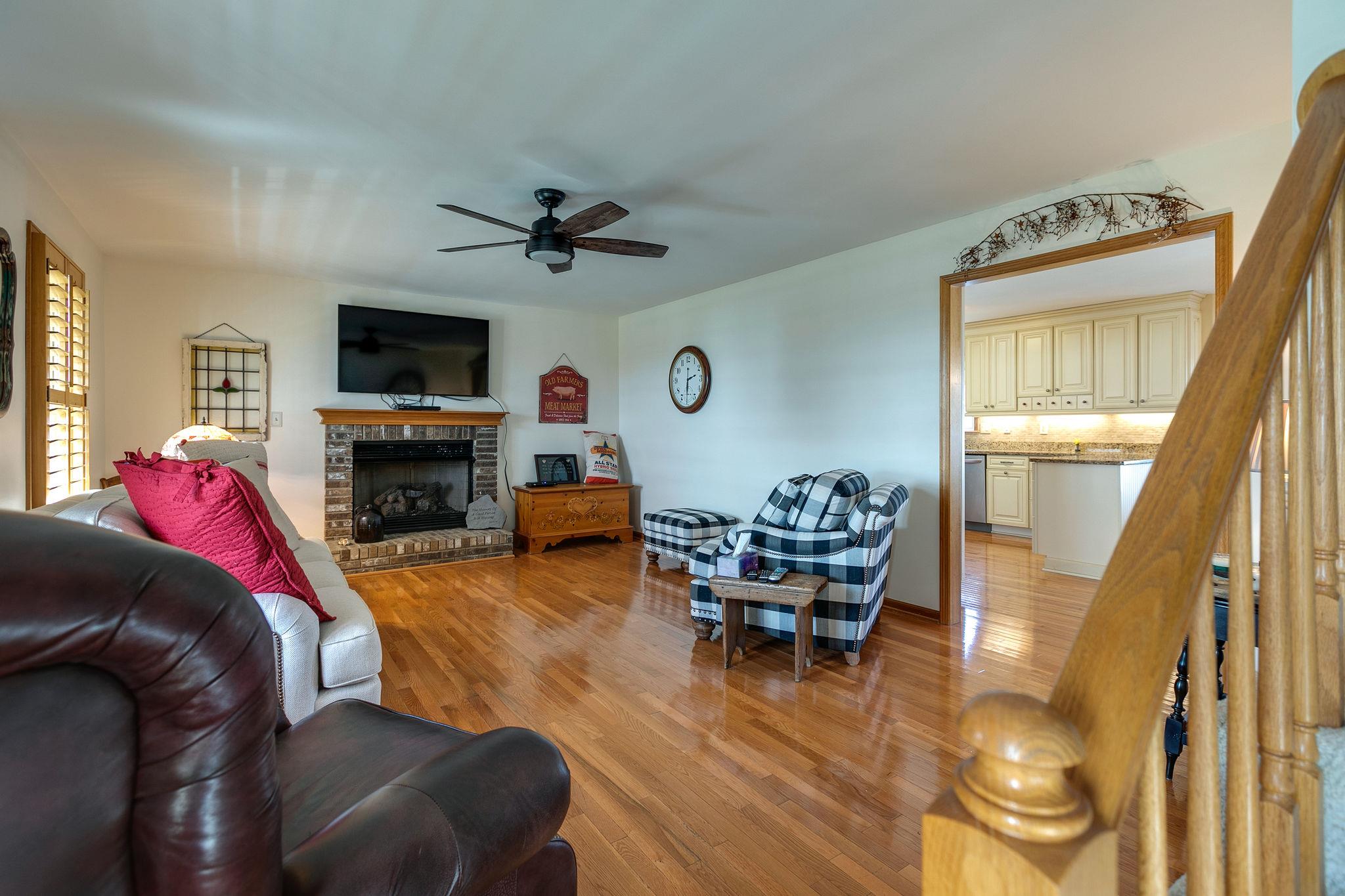 3467 Greens Mill Road Spring Hill, TN 37174 - Photo 21 of 28 a living room with furniture a fireplace and a flat screen tv