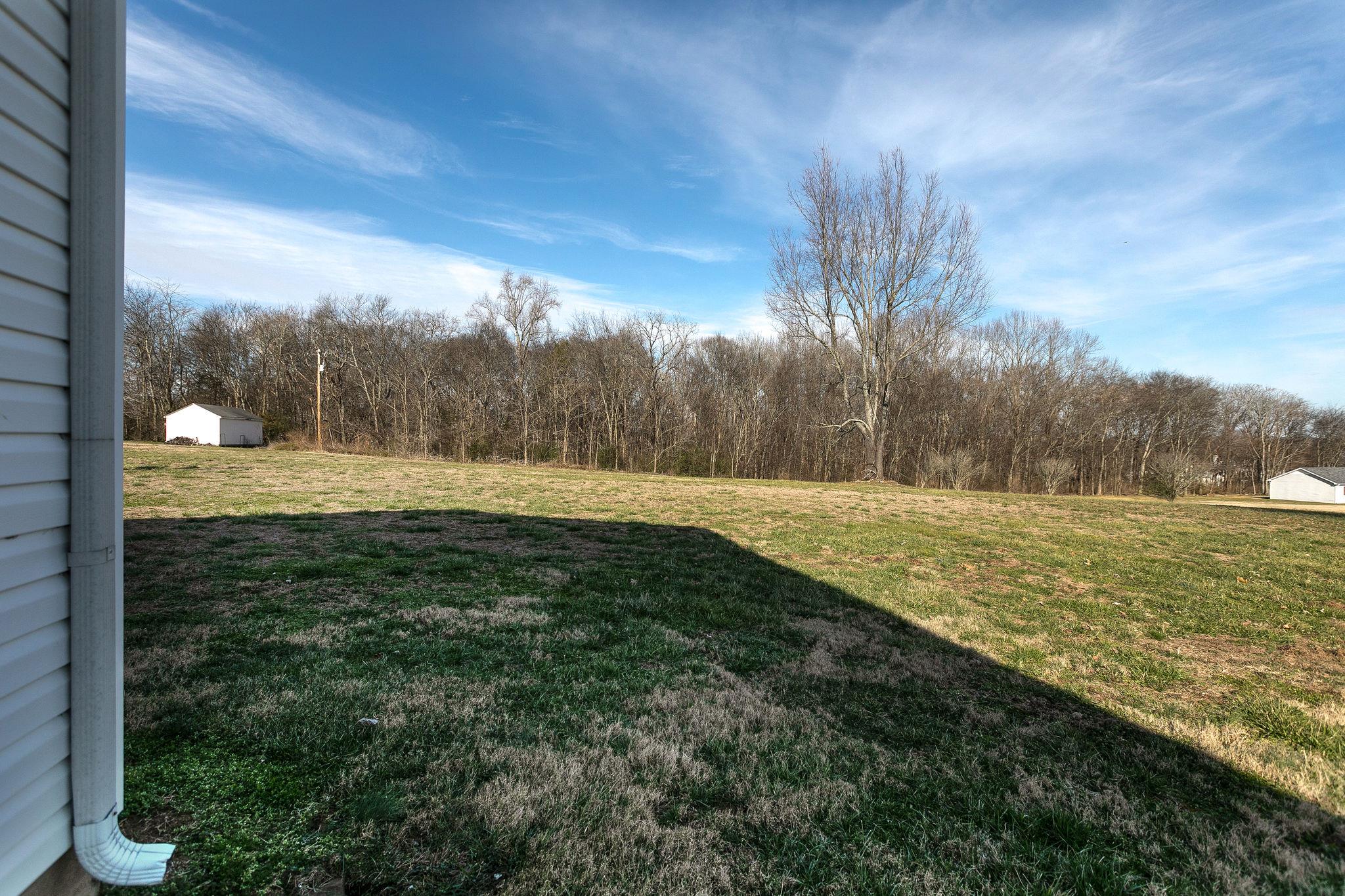 3467 Greens Mill Road Spring Hill, TN 37174 - Photo 25 of 28 a view of a field of grass and a building