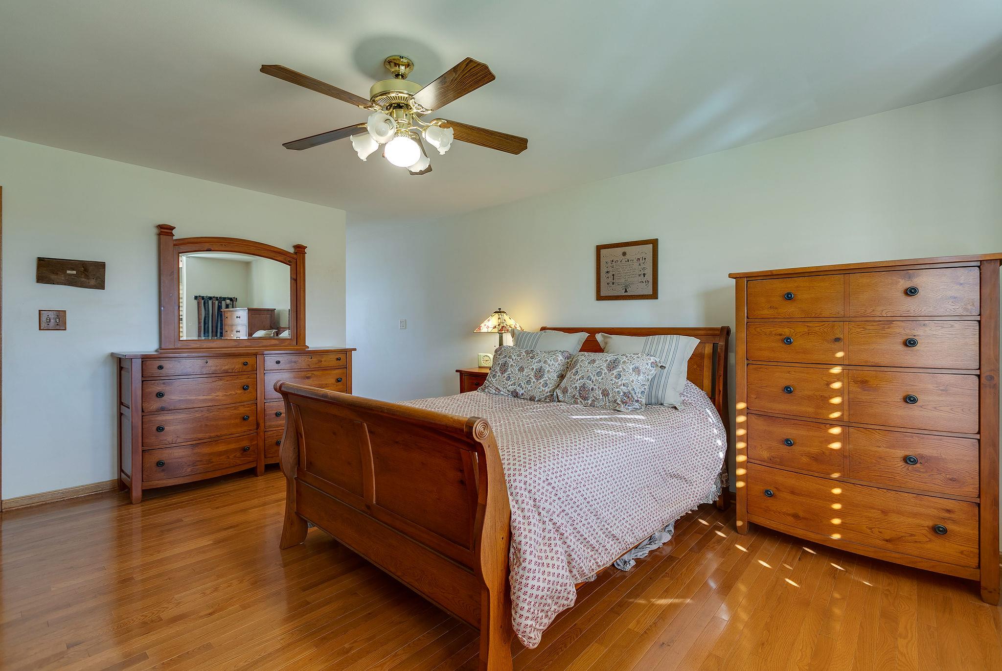 3467 Greens Mill Road Spring Hill, TN 37174 - Photo 7 of 28 a bedroom with a bed and a chandelier