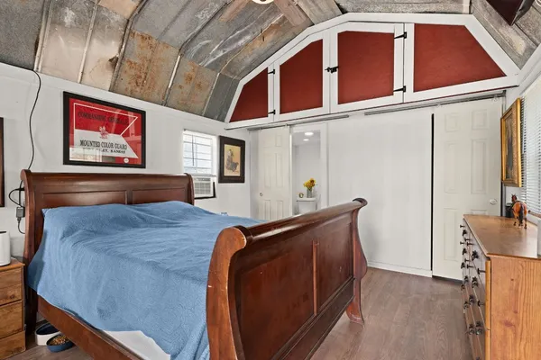a bedroom with a bed and dresser