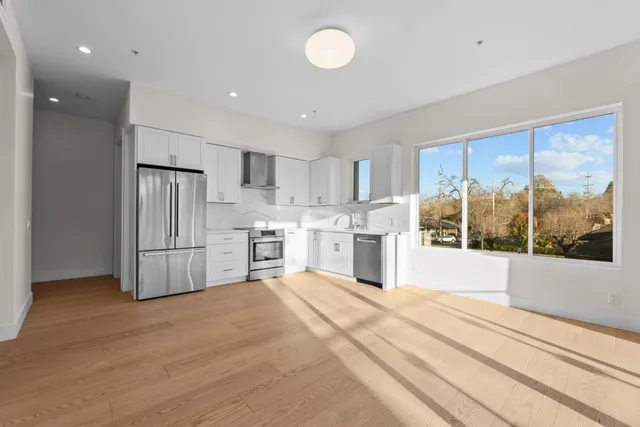 a bedroom with bed and a large window