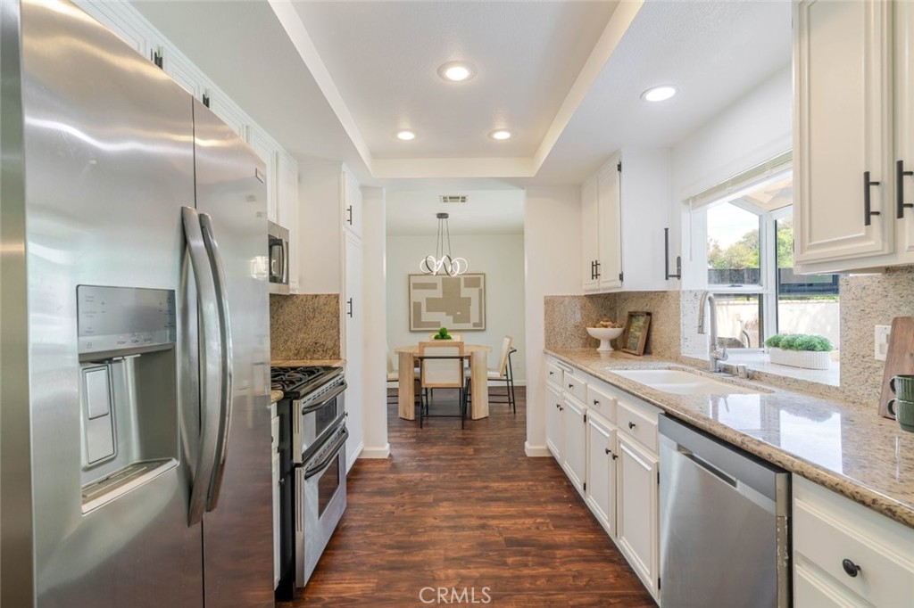 31256 Quail Valley Road Castaic, CA 91384 - Photo 11 of 31 a kitchen with stainless steel appliances granite countertop a refrigerator and a sink