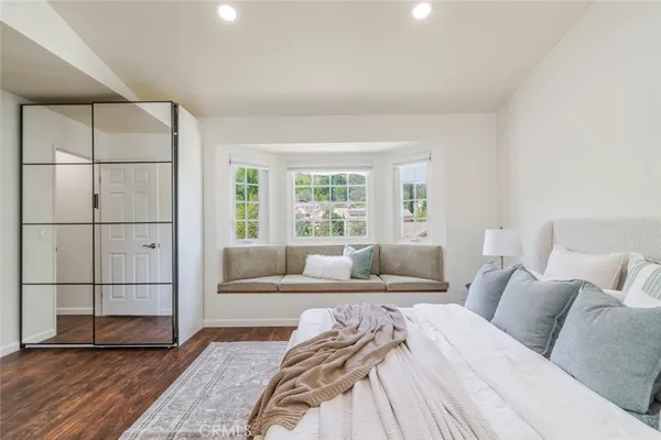 a bedroom with a large bed and a window
