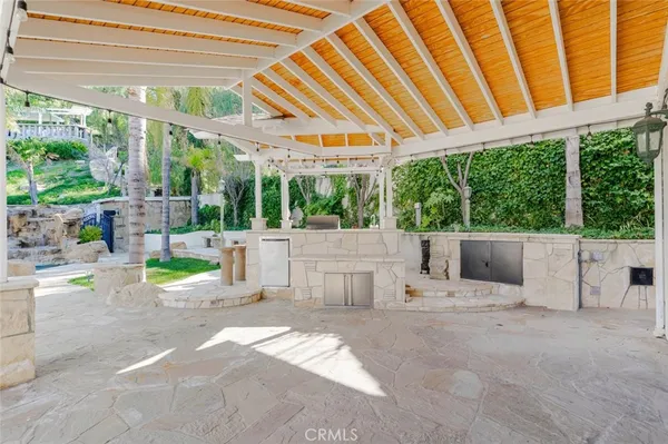 a backyard of a house with garden and outdoor seating