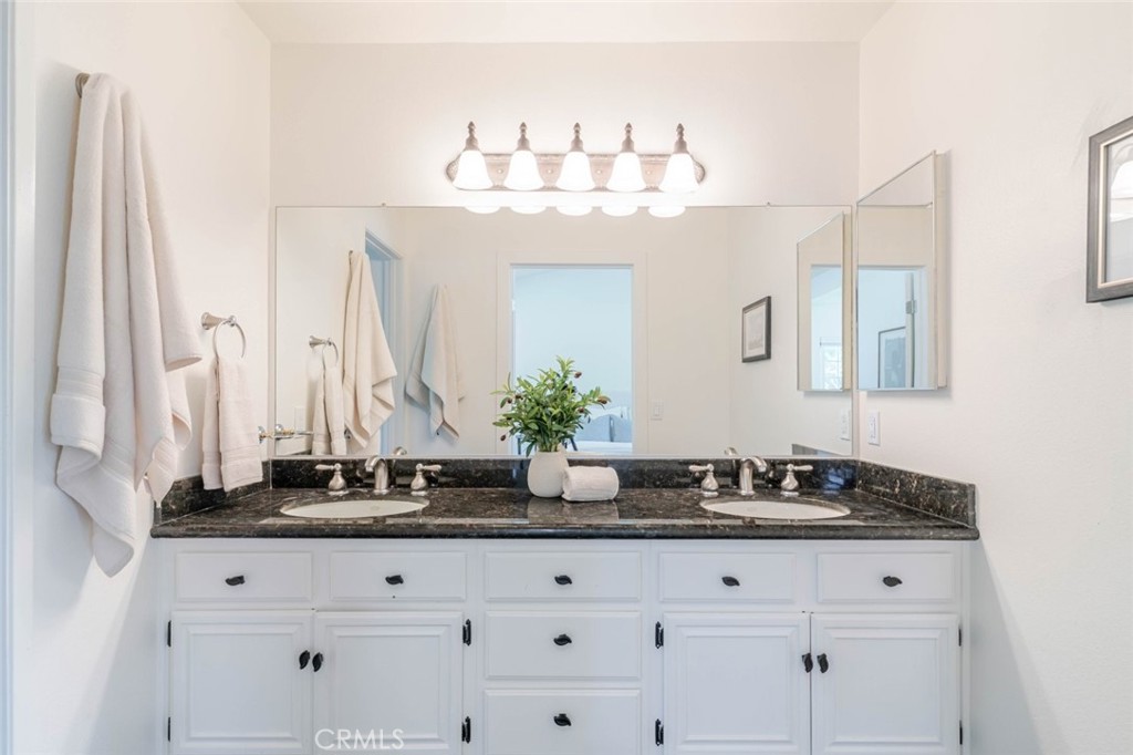 31256 Quail Valley Road Castaic, CA 91384 - Photo 20 of 31 a bathroom with granite countertop white cabinets and a sink