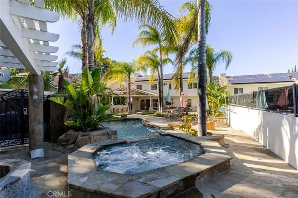 a view of a house with swimming pool and sitting area