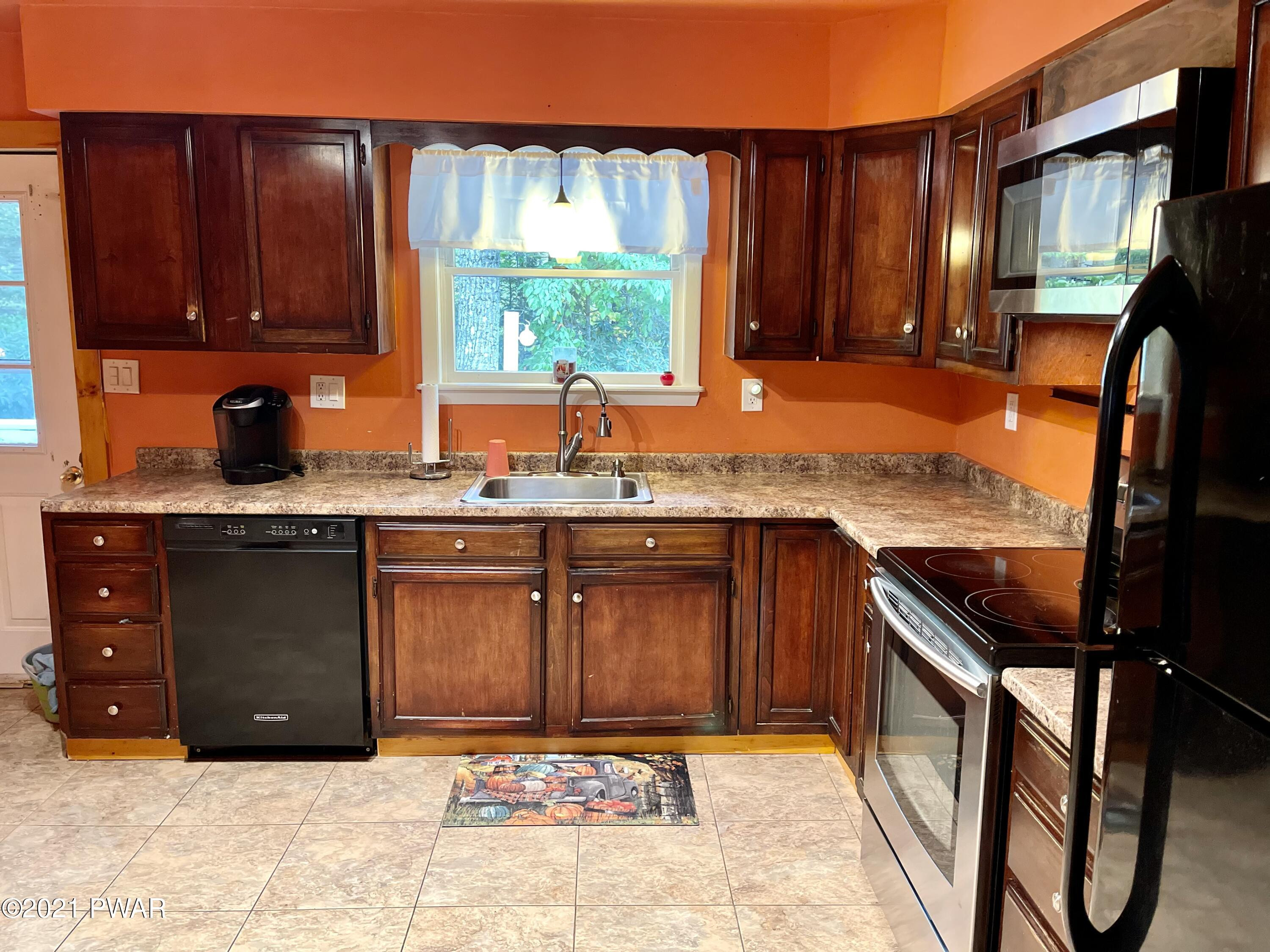 127 Estates Road Greentown, PA 18426 - Photo 54 of 85 a kitchen with stainless steel appliances granite countertop sink stove and cabinets