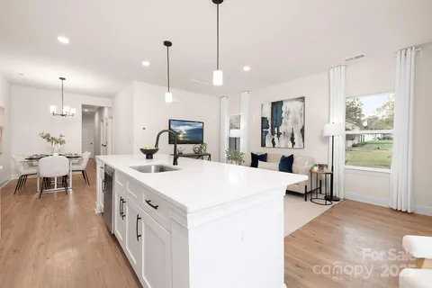 a large white kitchen with a table and chairs