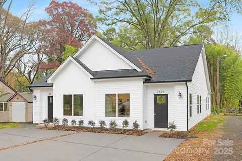 a front view of a house with trees
