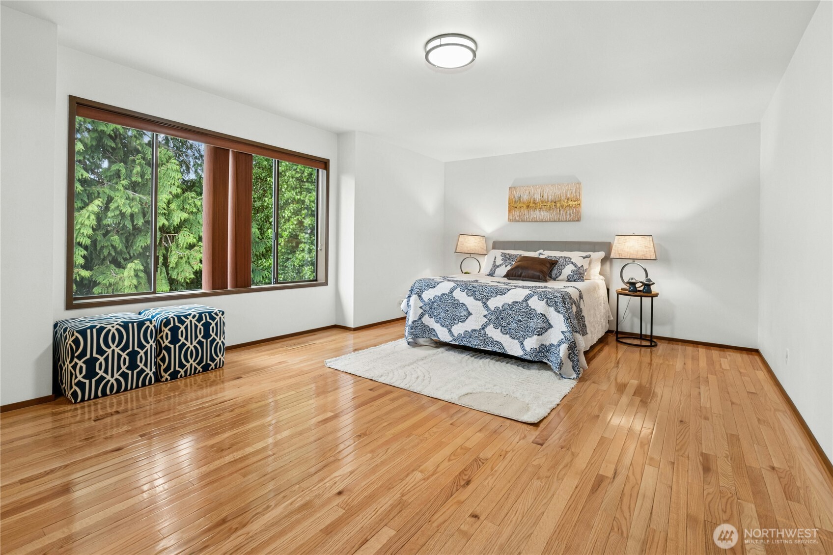 5211 103rd Street Southwest, Unit SW Mukilteo, WA 98275 - Photo 17 of 40 a bedroom with a bed and wooden floor