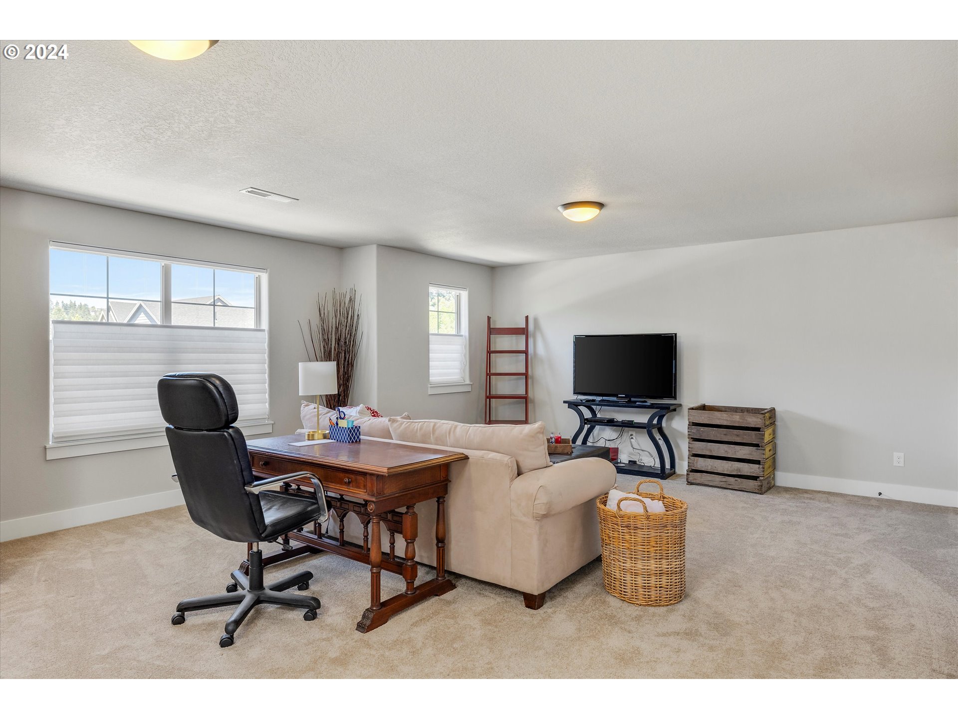 12934 Southwest Buckfield Lane Portland, OR 97224 - Photo 14 of 27 a living room with furniture and a flat screen tv