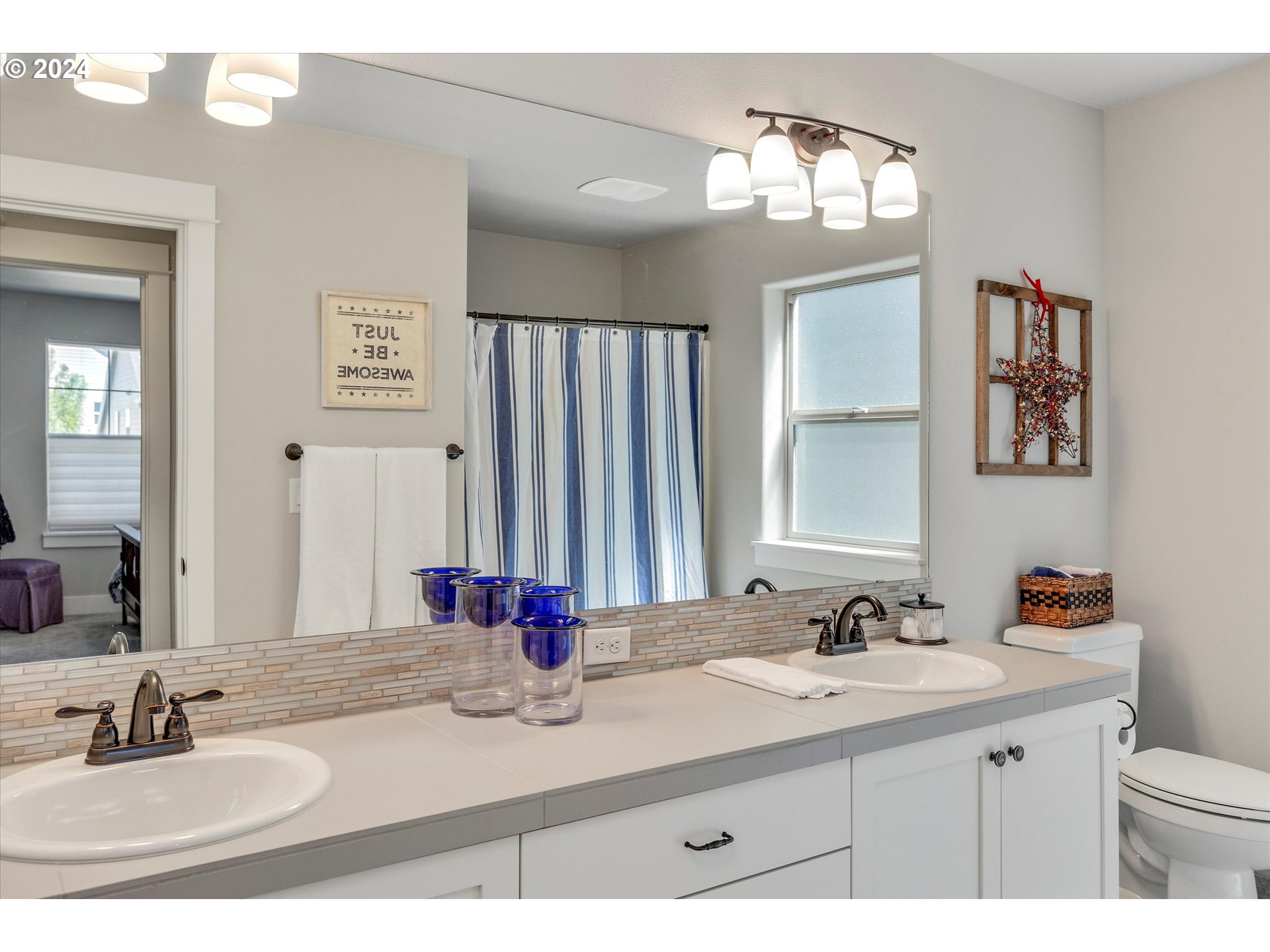 12934 Southwest Buckfield Lane Portland, OR 97224 - Photo 15 of 27 a bathroom with a sink double vanity and a mirror