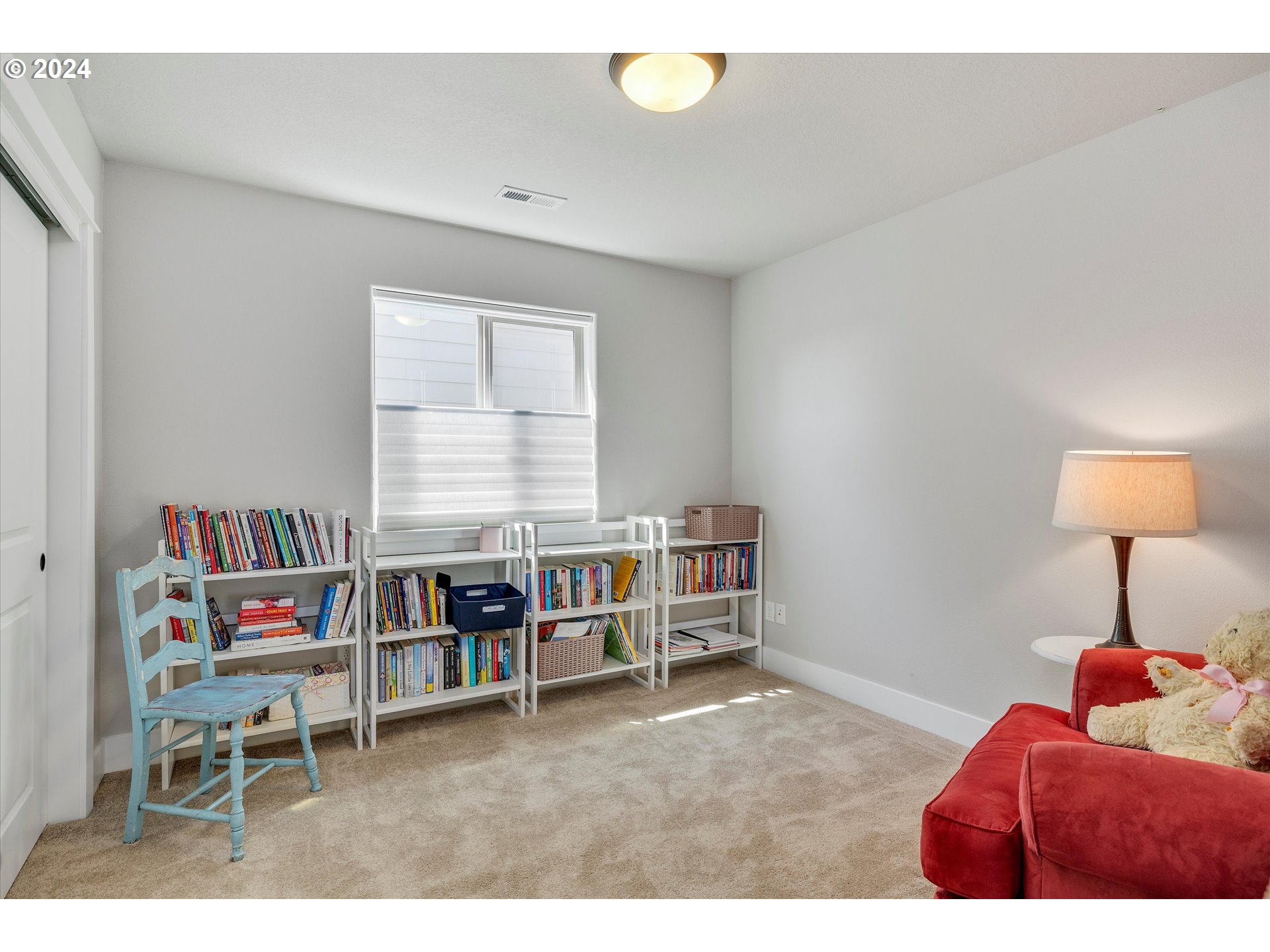 12934 Southwest Buckfield Lane Portland, OR 97224 - Photo 17 of 27 a living room with furniture and a book shelf