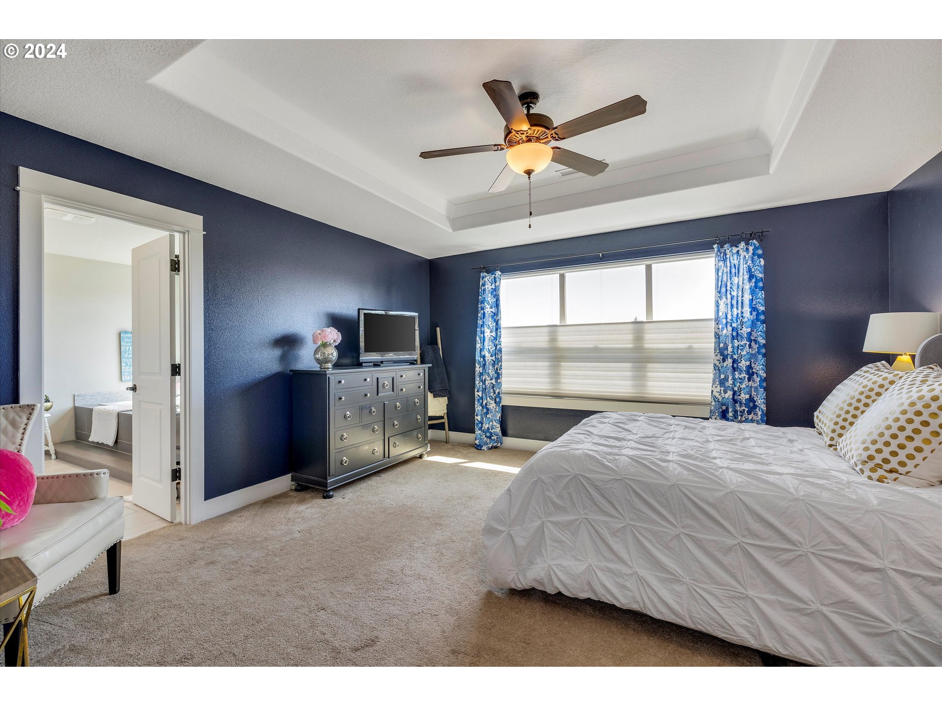 12934 Southwest Buckfield Lane Portland, OR 97224 - Photo 19 of 27 a bedroom with a large bed and a chandelier