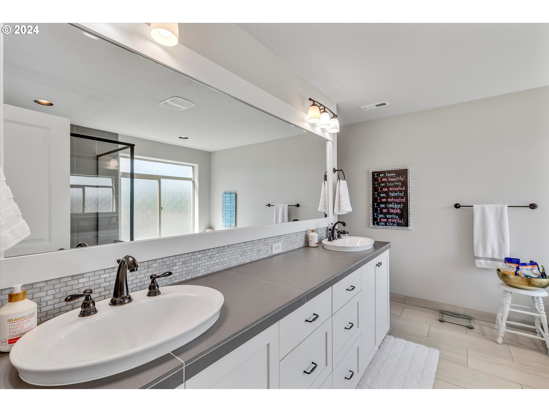 12934 Southwest Buckfield Lane Portland, OR 97224 - Photo 21 of 27 a bathroom with a sink and a mirror