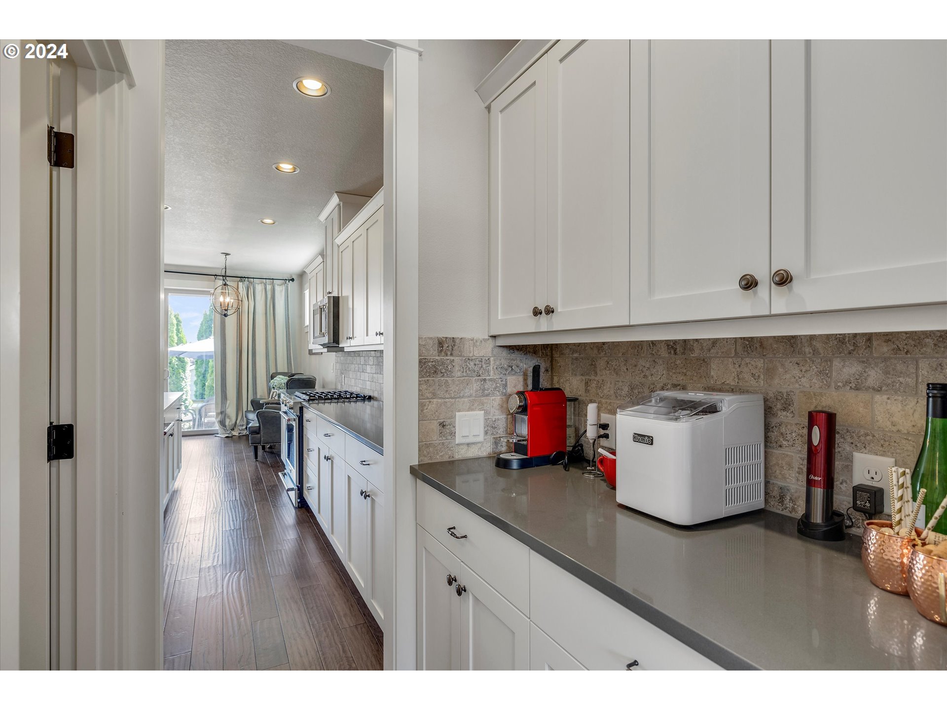12934 Southwest Buckfield Lane Portland, OR 97224 - Photo 4 of 27 a kitchen with cabinets and wooden floor
