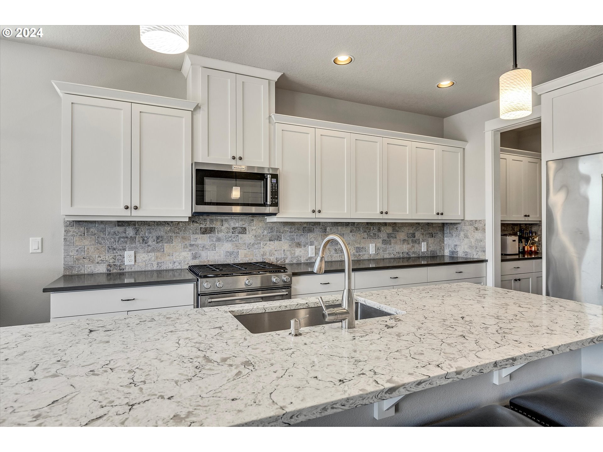 12934 Southwest Buckfield Lane Portland, OR 97224 - Photo 5 of 27 a kitchen with stainless steel appliances granite countertop a sink a stove and a microwave