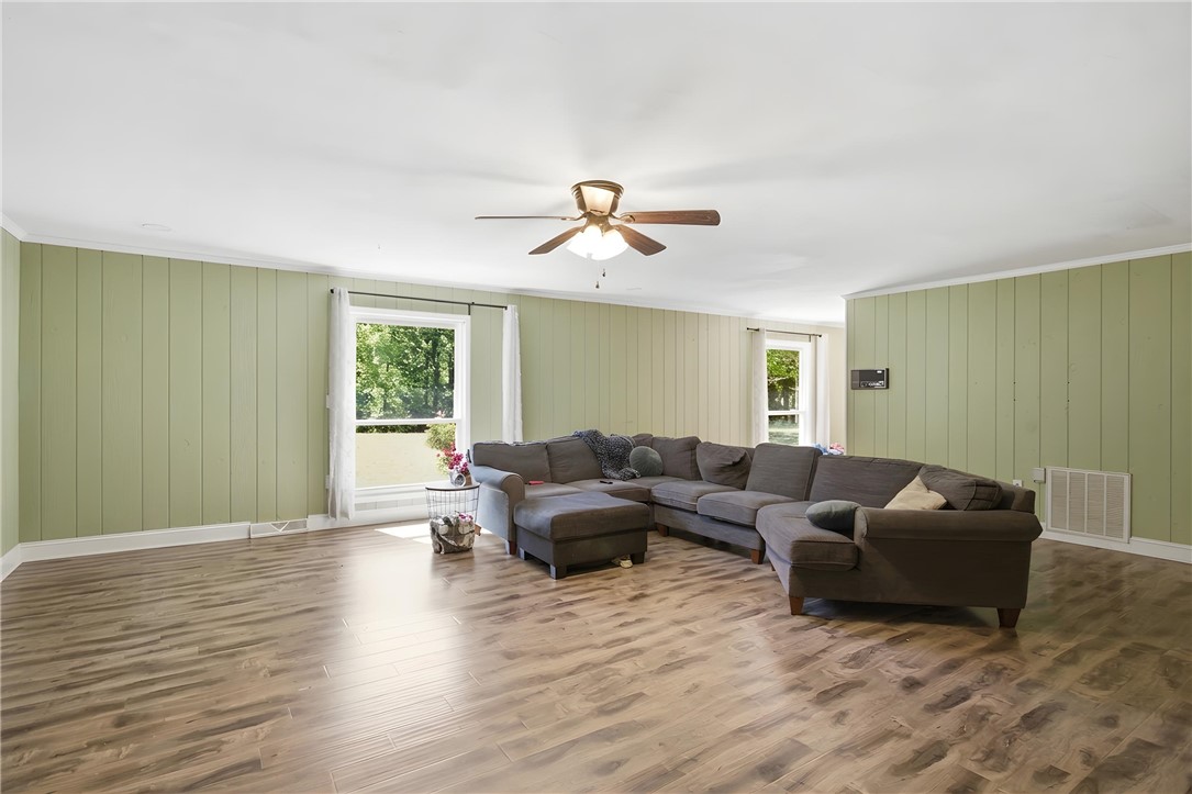 311 Cumberland Way Anderson, SC 29621 - Photo 5 of 44 Natural light bathes this spacious room, featuring ample wood flooring and a versatile layout.