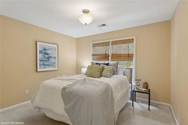a view of a hallway with a livingroom and a chandelier