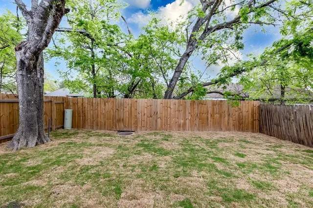 a view of small yard with wooden fence