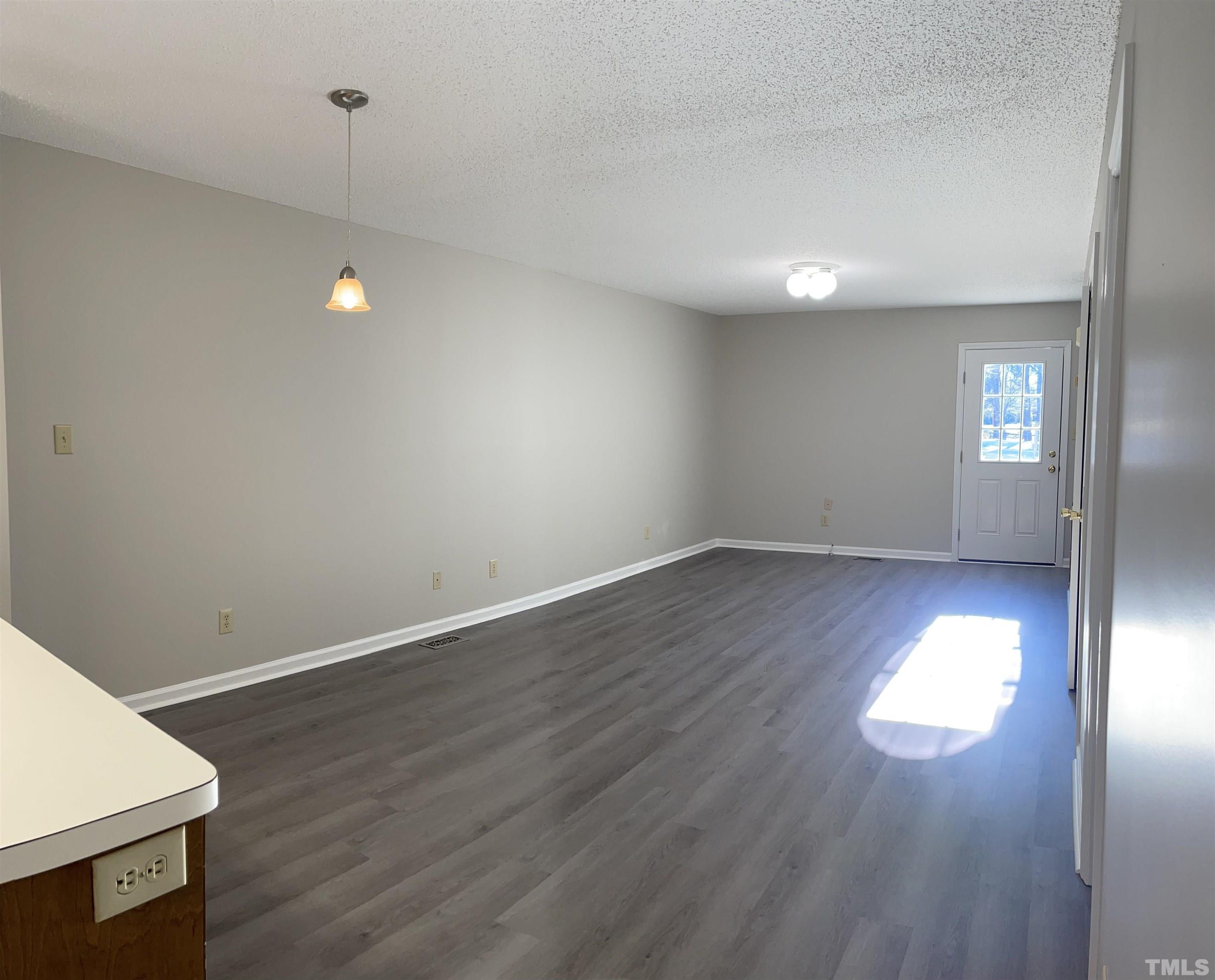 412 South Broad Street East, Unit 46 Angier, NC 27501 - Photo 1 of 16 an empty room with wooden floor and windows