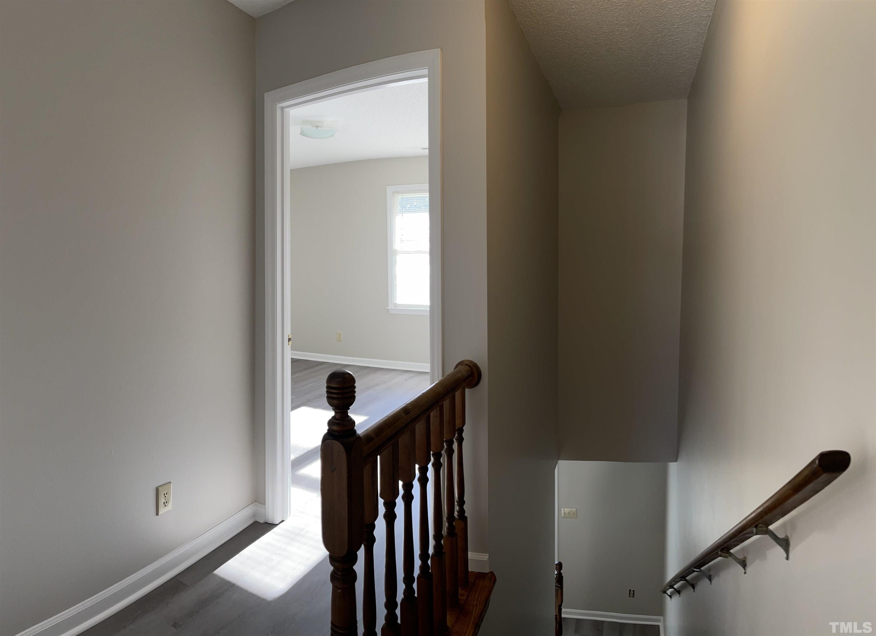 412 South Broad Street East, Unit 46 Angier, NC 27501 - Photo 16 of 16 a view of a hallway with wooden floor and staircase