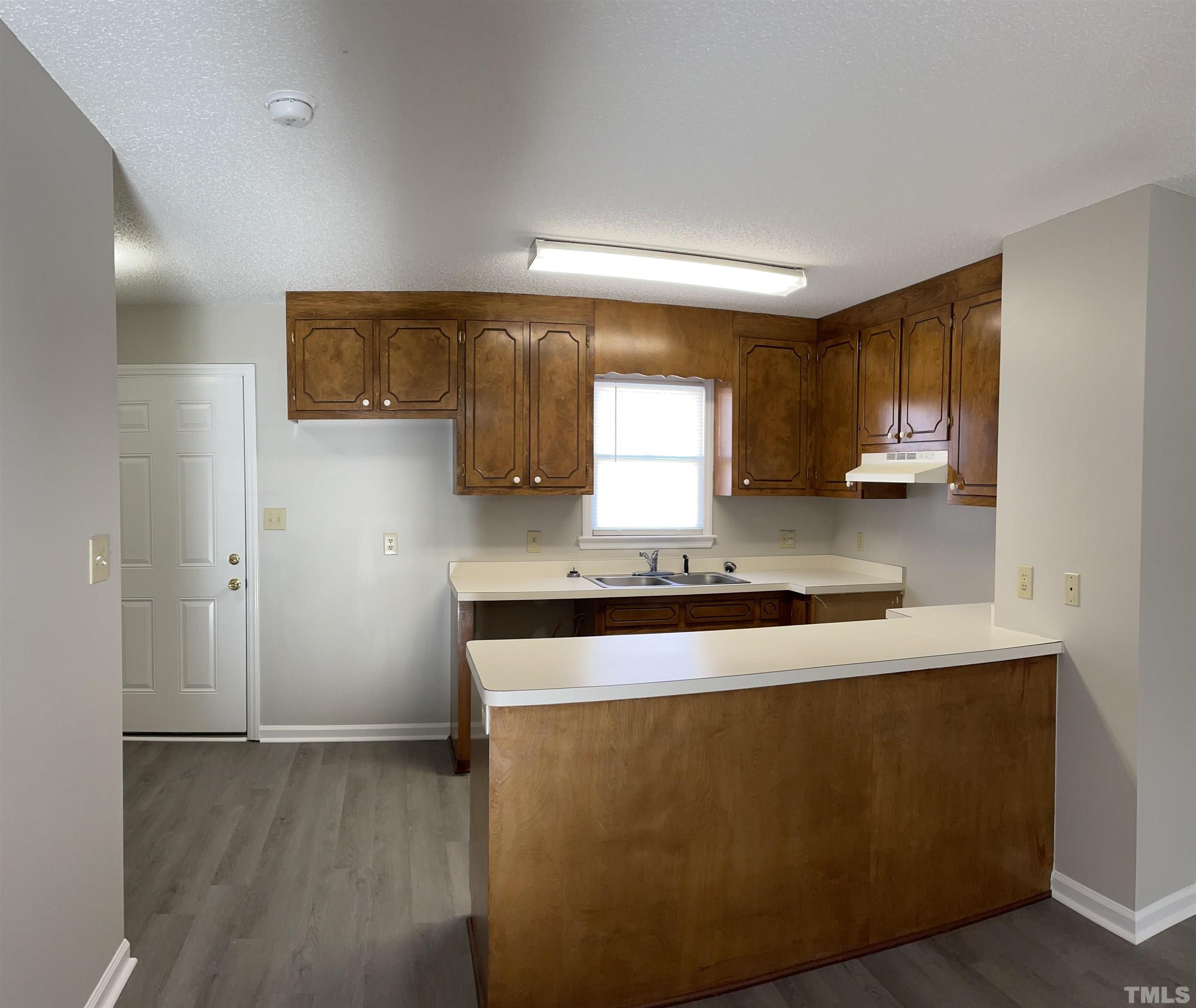 412 South Broad Street East, Unit 46 Angier, NC 27501 - Photo 2 of 16 a kitchen with stainless steel appliances granite countertop a stove a sink and a refrigerator