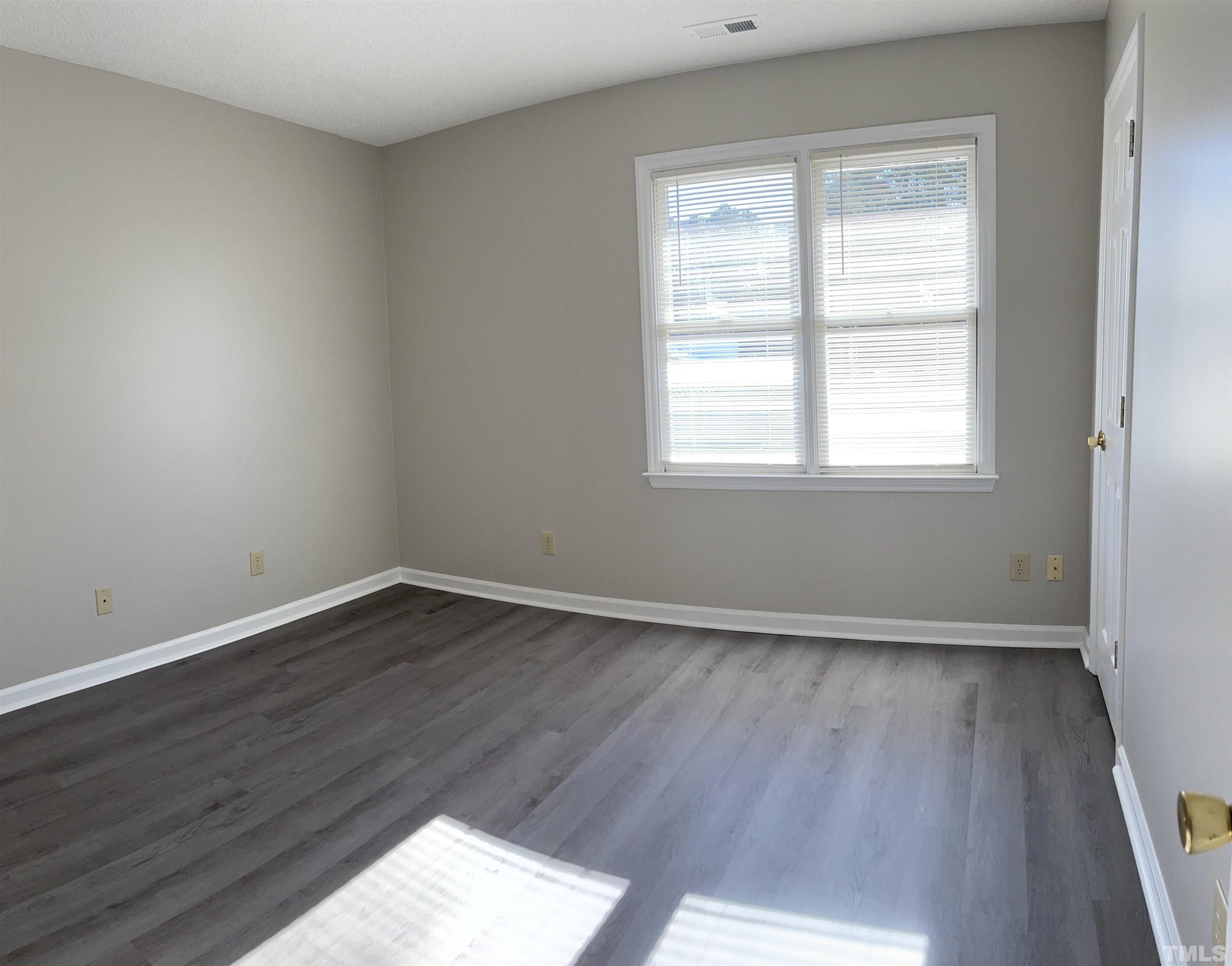 412 South Broad Street East, Unit 46 Angier, NC 27501 - Photo 6 of 16 an empty room with wooden floor and window