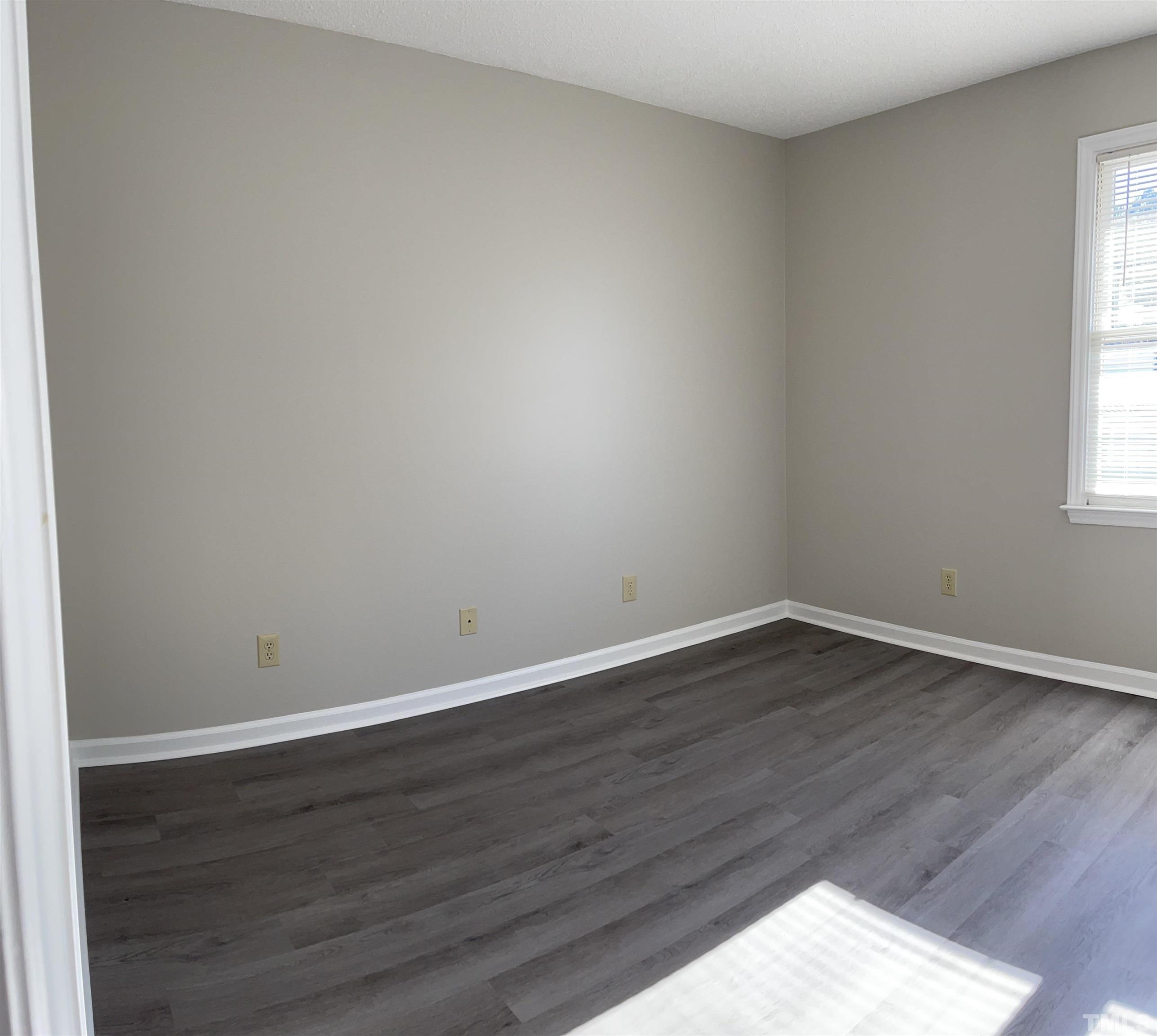 412 South Broad Street East, Unit 46 Angier, NC 27501 - Photo 7 of 16 a view of an empty room with wooden floor and a window