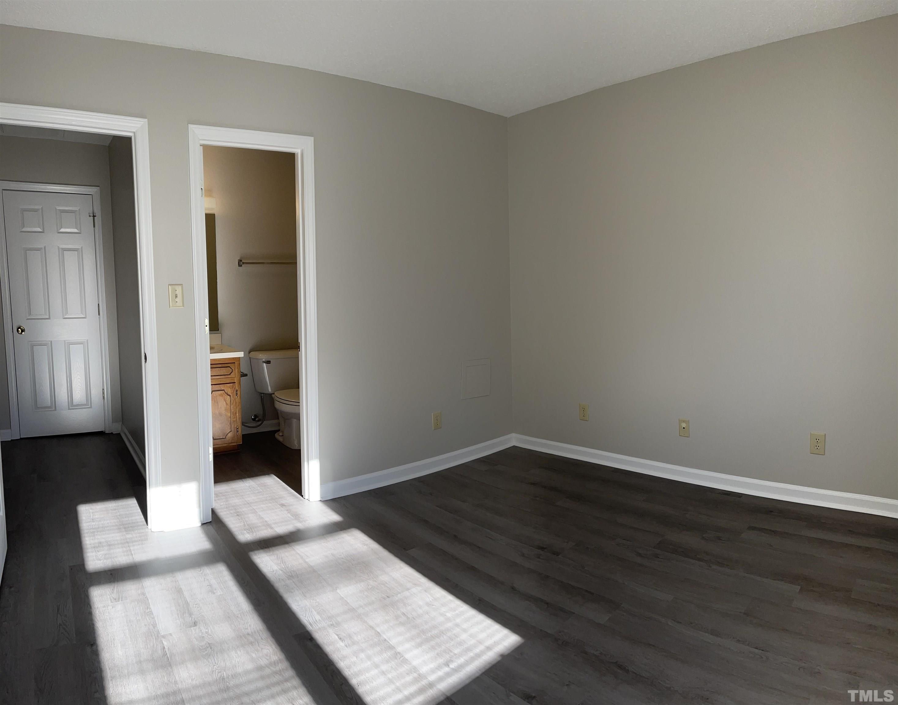 412 South Broad Street East, Unit 46 Angier, NC 27501 - Photo 9 of 16 an empty room with wooden floor and a bathroom