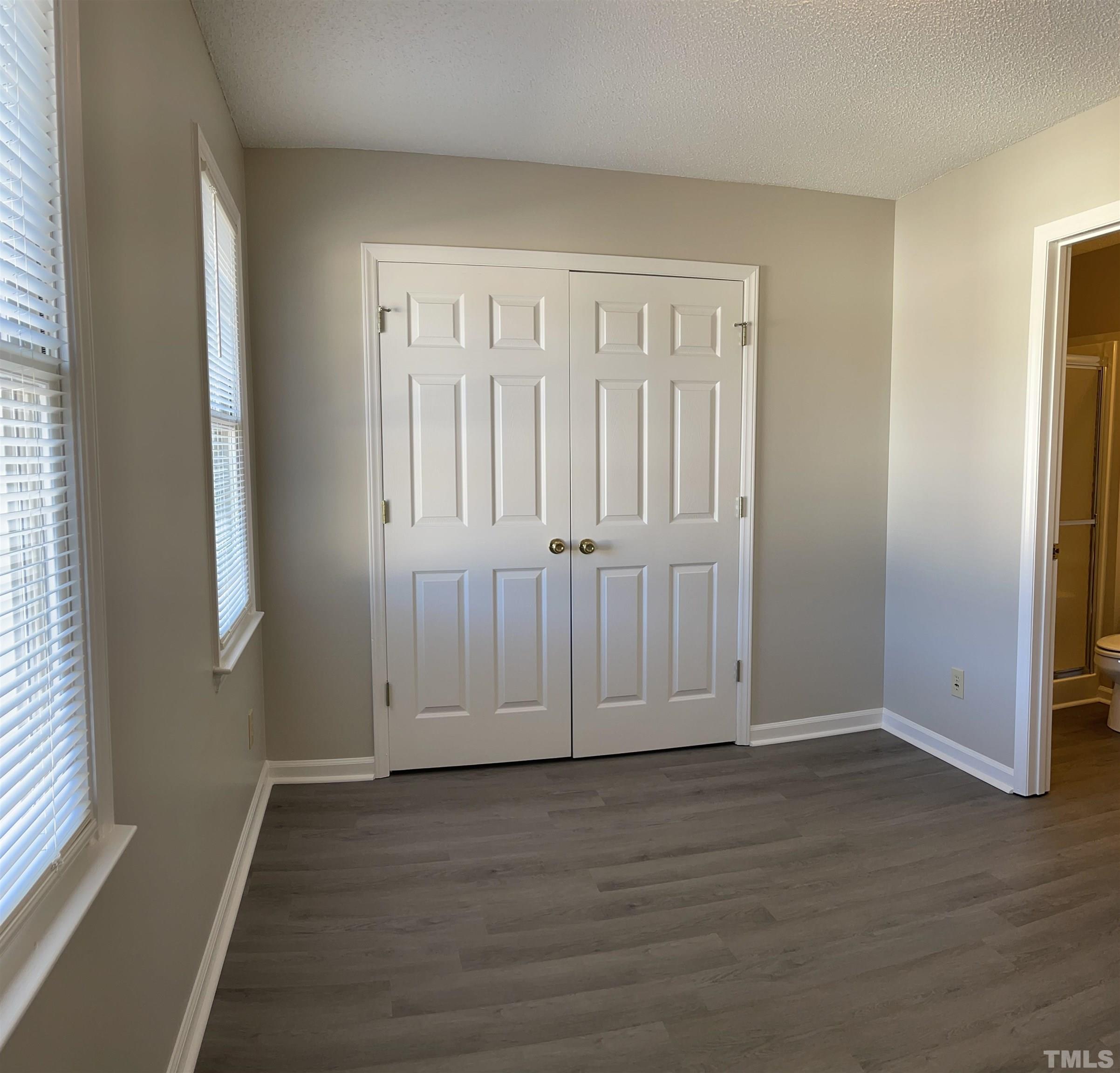 412 South Broad Street East, Unit 46 Angier, NC 27501 - Photo 10 of 16 an empty room with wooden floor and windows