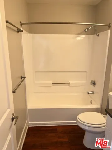 a view of an empty room and wooden floor