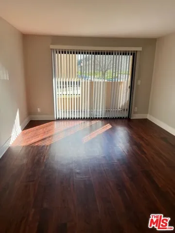 a view of a room with wooden floor