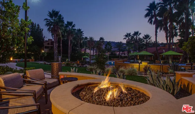 a view of a swimming pool with outdoor seating