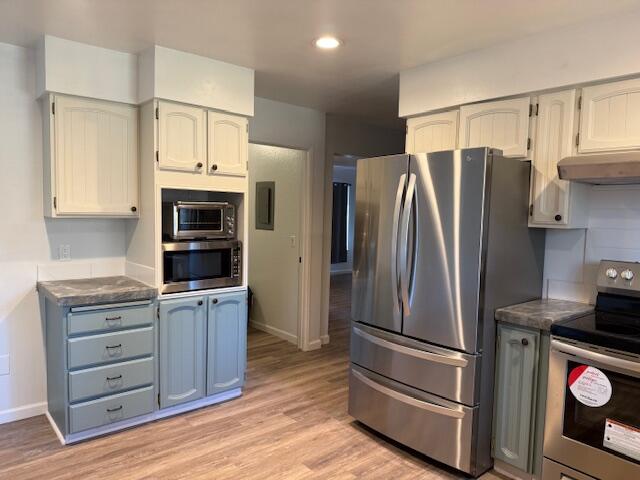 20612 Burney Court Burney, CA 96013 - Photo 4 of 40 a kitchen with stainless steel appliances a refrigerator stove and cabinets