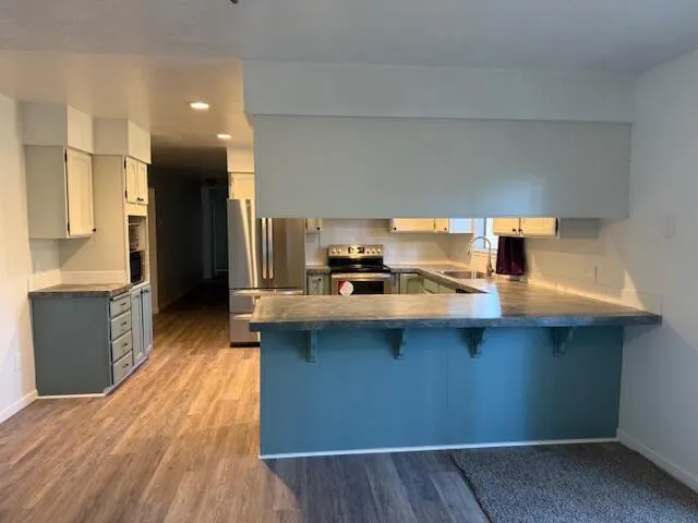 a bathroom with a granite countertop sink a toilet and a mirror