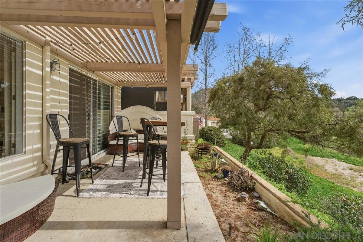 29585 Circle R Greens Drive Escondido, CA 92026 - Photo 23 of 40 a view of a patio with dining table and chairs with wooden floor and fence