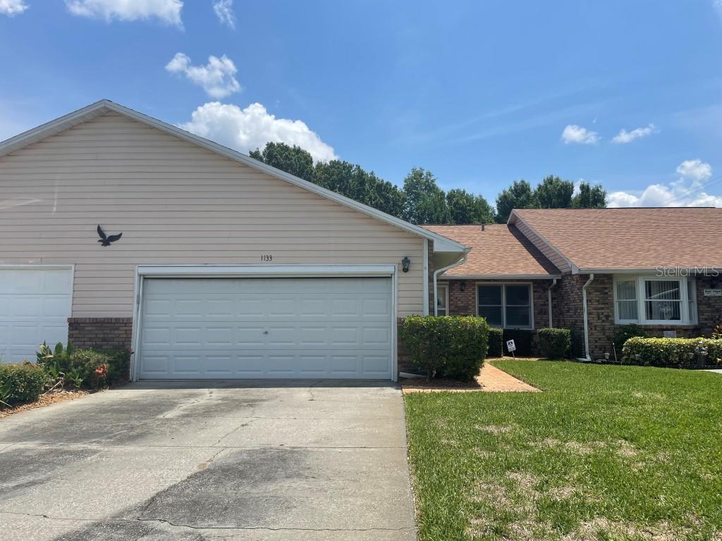 1133 Monroe Avenue St. Cloud, FL 34769 - Photo 1 of 1 a front view of house with yard and green space