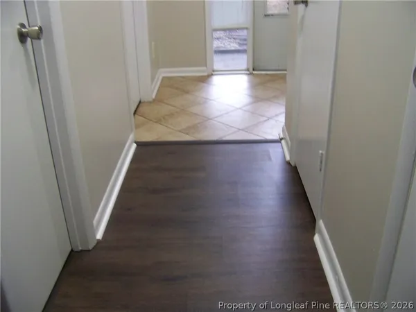 a view of a hallway with wooden floor