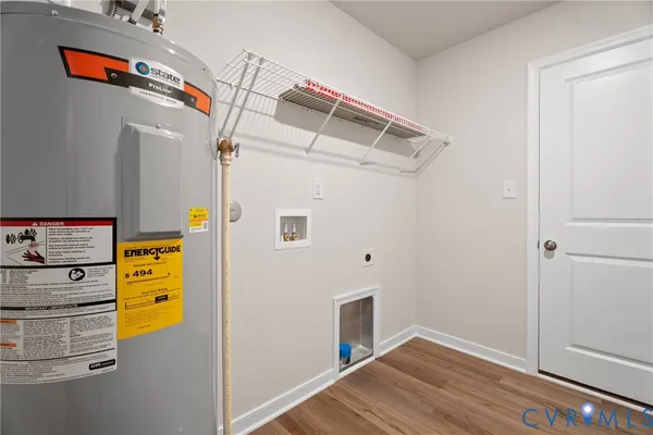 a view of walk in closet with wooden floor