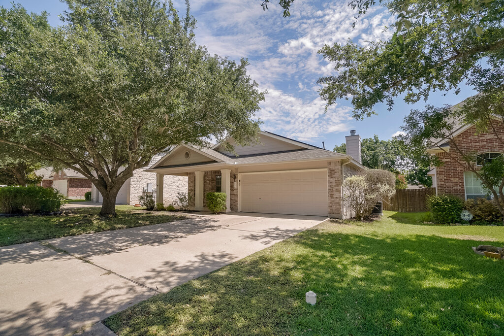2724 Kickapoo Cavern Drive Pflugerville, TX 78660 - Photo 3 of 24 A welcoming brick exterior home with an attached garage and mature shade trees defines curb appeal.