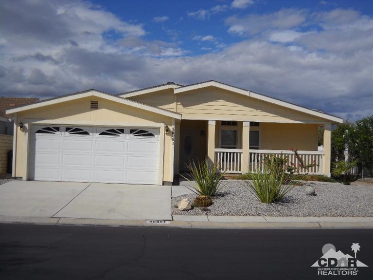38881 Parker Ridge Way Palm Desert, CA 92260 - Photo 1 of 7 a front view of a house with garden