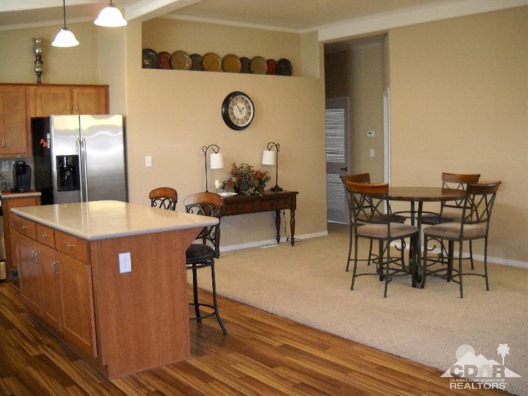 38881 Parker Ridge Way Palm Desert, CA 92260 - Photo 3 of 7 a kitchen with a table chairs and a stove