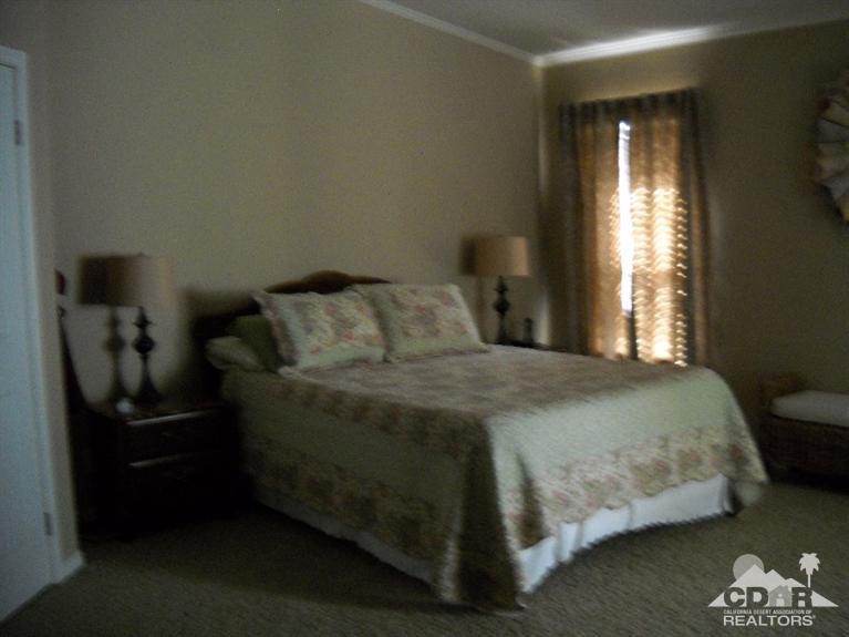 38881 Parker Ridge Way Palm Desert, CA 92260 - Photo 4 of 7 a bedroom with a bed and a window
