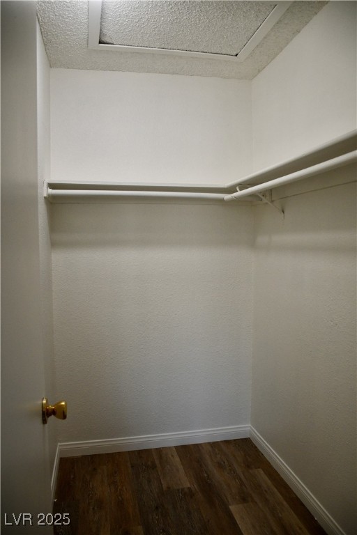 6925 Hopkins Drive, Unit 3 Las Vegas, NV 89156 - Photo 9 of 12 Spacious closet featuring dark wood finished floors
